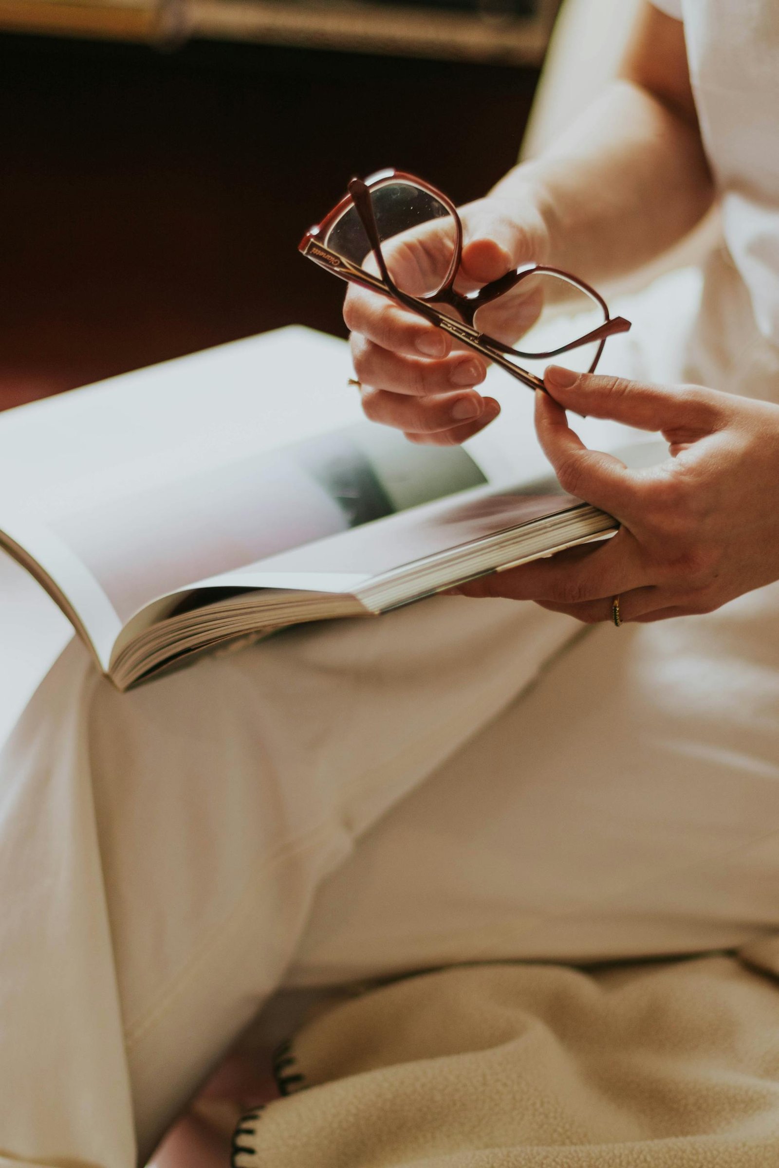 A healthy woman relaxing with Eyeglasses and Book